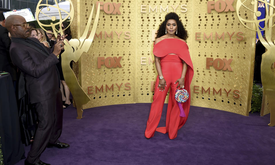 Courtney B. Vance, left, takes a photograph of Angela Bassett as they arrive at the 71st Primetime Emmy Awards on Sunday, Sept. 22, 2019, at the Microsoft Theater in Los Angeles. (Photo by Jordan Strauss/Invision/AP)