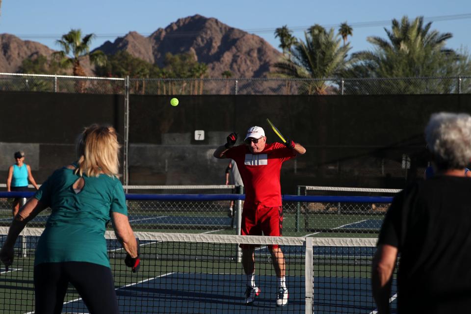 Roy Watson, center, of Indio returns the ball to Jenna Bley of Palm Desert on one of 16 pickleball courts at Fritz Burns Park in La Quinta, Calif., on Wednesday morning., Oct. 18, 2023.