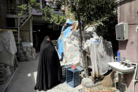 In this Saturday, July 6, 2019 photo, Zeinab Ebrahimi, 56, stands at the courtyard of her house which is under renovation, in the old District 12 of Tehran, Iran. Iran’s large middle class has been hit hard by the fallout from unprecedented U.S. sanctions, including the collapse of the national currency. Perhaps most devastating has been the doubling of housing prices. The spike has uprooted tenants and made home ownership unattainable for most. (AP Photo/Ebrahim Noroozi)