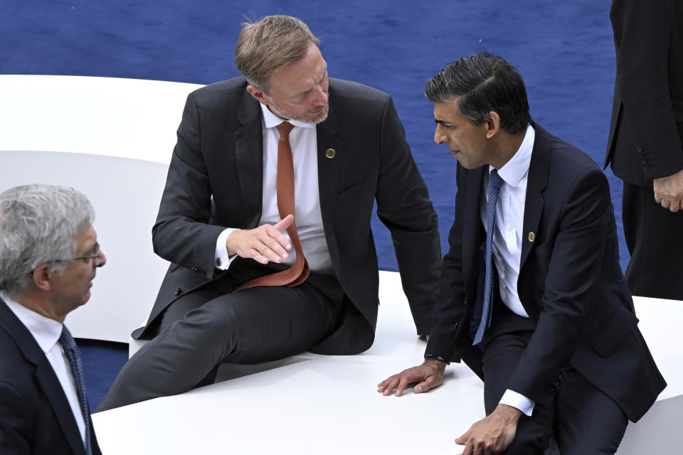 German Finance Minister Christian Lindner, center, gestures as he speaks with Britain's Finance Minister Rishi Sunak, right, during a G7 Finance Ministers Meeting at the federal guest house Petersberg, near Bonn, Germany, Thursday, May 19, 2022. (Federico Gambarini/dpa via AP)