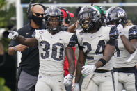 Central Florida running back Greg McCrae (30) celebrates his 3-yard touchdown run against Tulane with teammate running back Bentavious Thompson (24) during the first half of an NCAA college football game, Saturday, Oct. 24, 2020, in Orlando, Fla. (AP Photo/John Raoux)