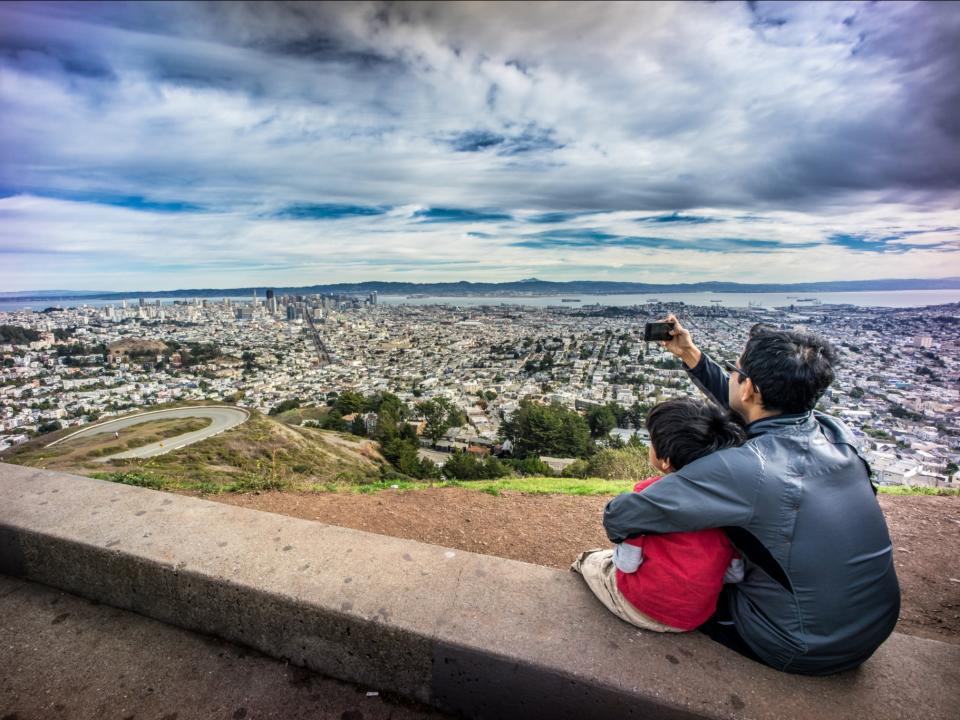 Father and son taking photo of San Francisco