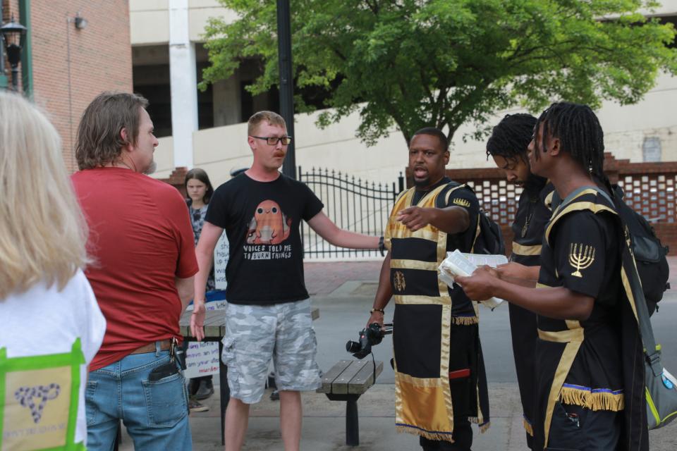 Unwelcome activists read from the Bible during the Reproductive Rights Protesting, Augusta rally in the Augusta Commons on Saturday, May 21, 2022.