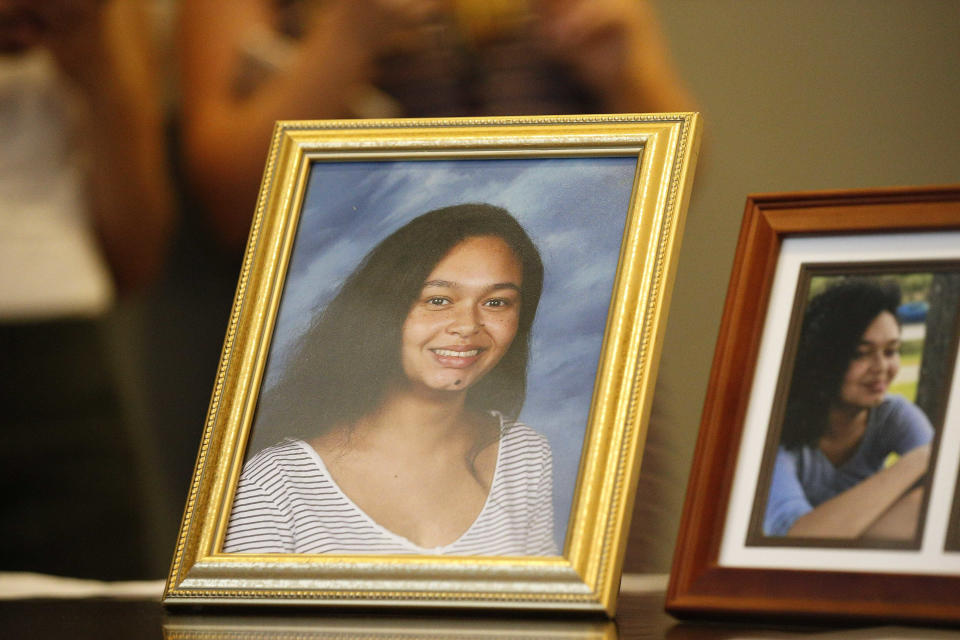 FILE - Photos of Parkland High School shooting victim Helena Ramsay sit on a table as her parents speak to the media during a news conference, in Fort Lauderdale, Fla., on June 15, 2018. (AP Photo/Brynn Anderson, File)