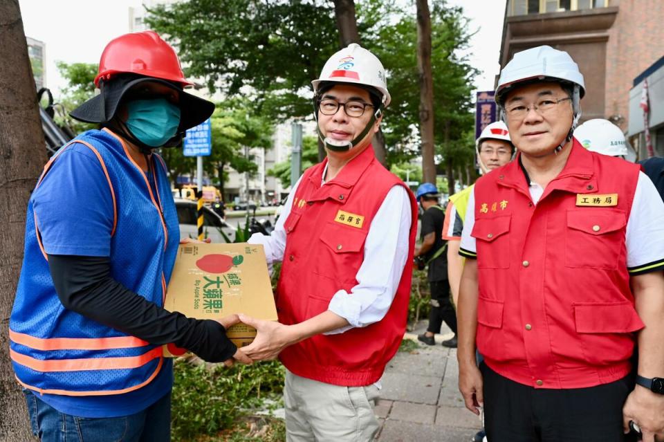 陳其邁(中)颱風天慰問辛苦清理環 境的工作人員。   圖：高雄市政府提供