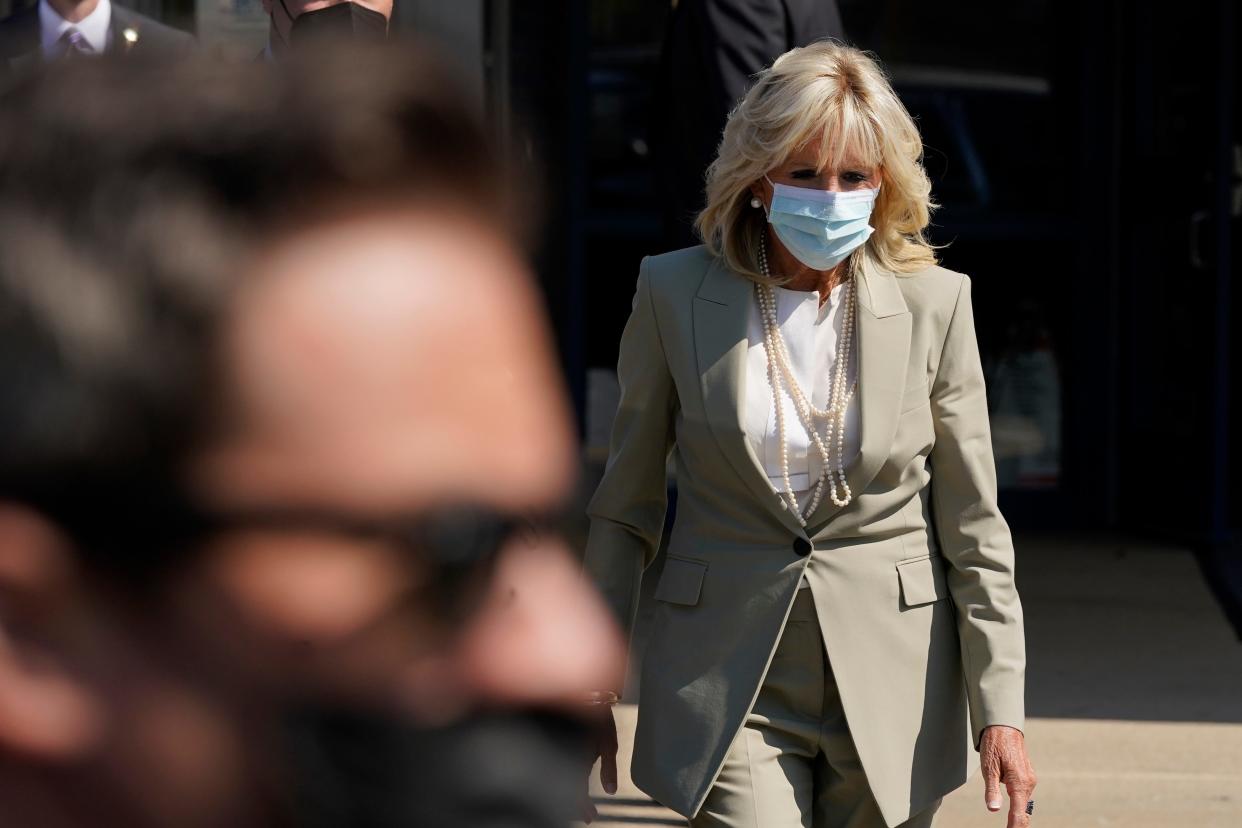 First lady Jill Biden walks to talk to the media about President Joe Biden testing positive for COVID-19, as she arrives to visit Schulze Academy, Thursday, July 21, 2022, in Detroit.