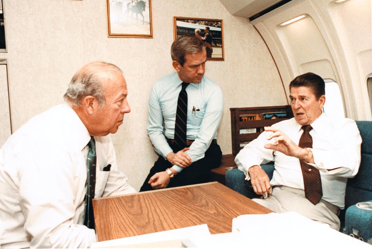 Ronald Reagan with staff aboard Air Force One.