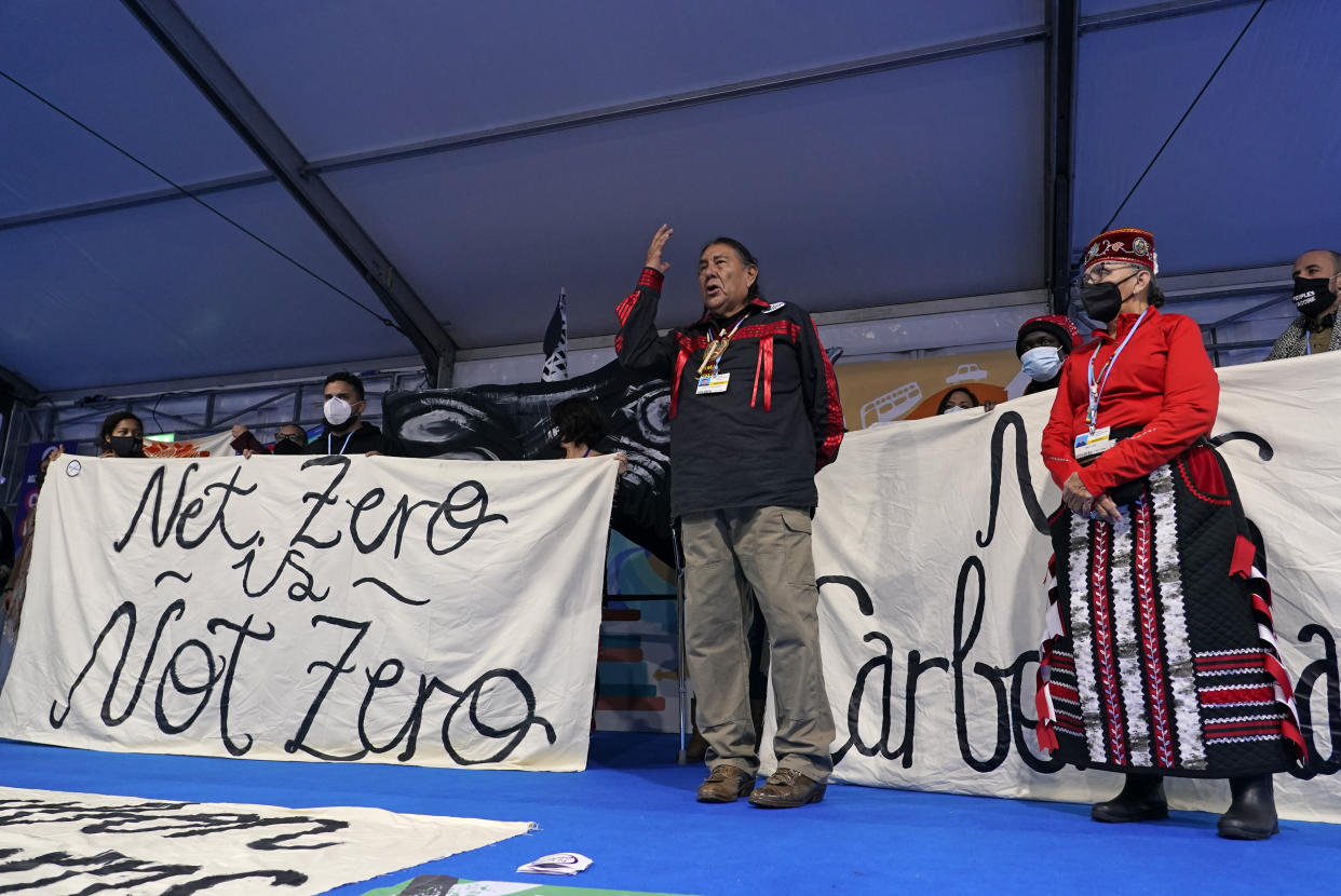 Bruce Kendall Goldtooth, environmental, climate, and economic justice activist, gestures as he speaks during a protest inside the venue of the COP26 U.N. Climate Summit in Glasgow, Scotland, Tuesday, Nov. 9, 2021. The U.N. climate summit in Glasgow has entered it's second week as leaders from around the world, are gathering in Scotland's biggest city, to lay out their vision for addressing the common challenge of global warming. (AP Photo/Alberto Pezzali)