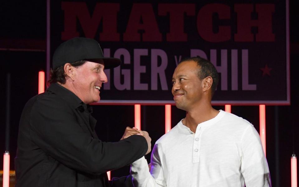 The two adversaries shake hands after Phil Mickelson's victory - Getty Images North America