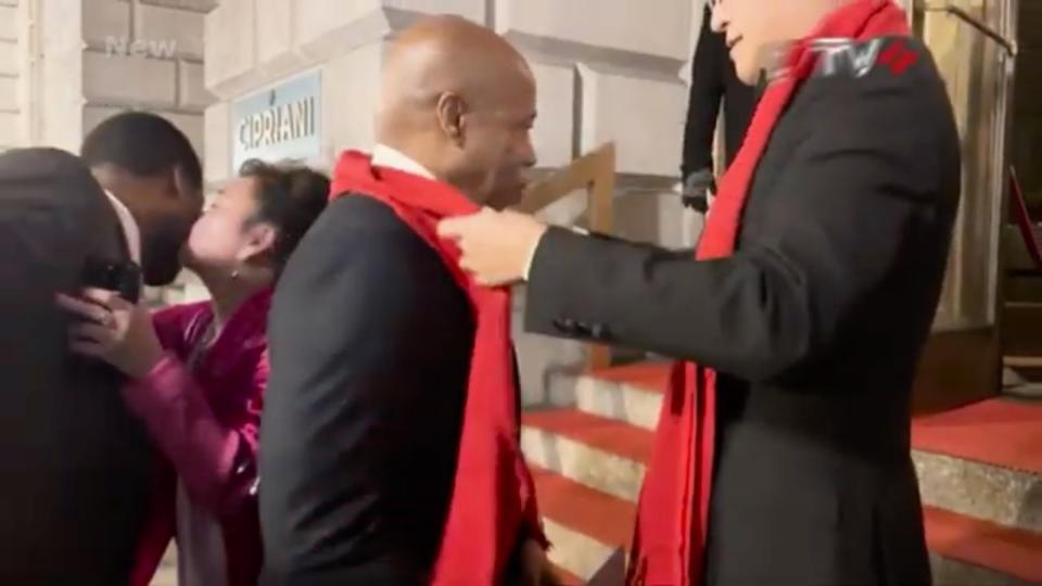 A greeter drapes a red scarf around Eric Adams’ neck at a Chinese Lunar New Year event at Cipriani Downtown last month. CCTV+