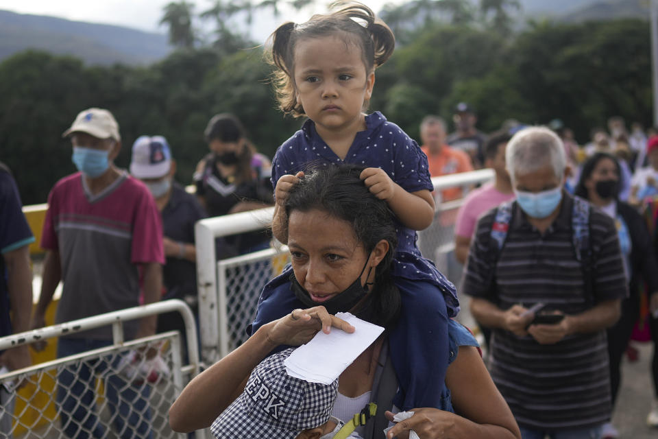 Alejandra Gomez, with her children in tow; Ariagni Quintero, top, and Samuel Quintero, as they use the Simon Bolivar International Bridge to cross between San Antonio, Venezuela and Cucuta, Colombia, Friday, Aug. 5, 2022, on the border that is open to pedestrian traffic but closed to cargo trucks. "I want to regularize my papers in Colombia so I can get a better job on the other side", says Gomez. (AP Photo/Matias Delacroix)