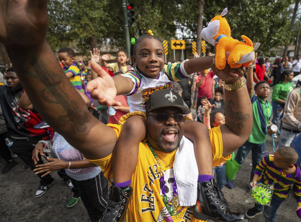 The Krewe of NOMTOC rolls through Algiers in New Orleans, Saturday, Feb. 10, 2024. (David Grunfeld/The Times-Picayune/The New Orleans Advocate via AP)