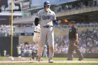 Los Angeles Dodgers designated hitter Shohei Ohtani (17) walks back to the dugout after being tagged out at home plate by Minnesota Twins catcher Christian Vázquez to end the top of the seventh inning of a baseball game Wednesday, April 10, 2024, in Minneapolis. (AP Photo/Abbie Parr)