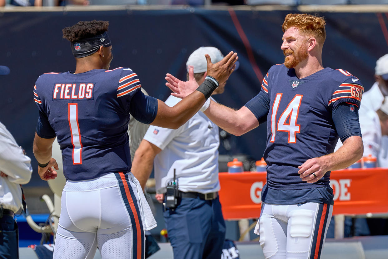 CHICAGO, IL - AUGUST 14: Chicago Bears quarterback Andy Dalton (14) shake hands with Chicago Bears quarterback Justin Fields (1) during a preseason game between the Chicago Bears and the Miami Dolphins on August 14, 2021 at Soldier Field in Chicago, IL. (Photo by Robin Alam/Icon Sportswire via Getty Images)