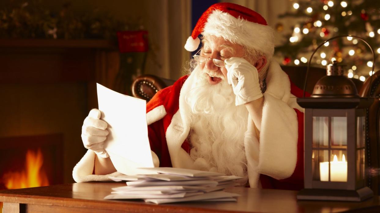 jolly father christmas reading letters from children