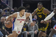 Detroit Pistons guard Cade Cunningham, left, drives to the basket against Golden State Warriors forward Jonathan Kuminga (00) during the first half of an NBA basketball game in San Francisco, Friday, Jan. 5, 2024. (AP Photo/Jeff Chiu)