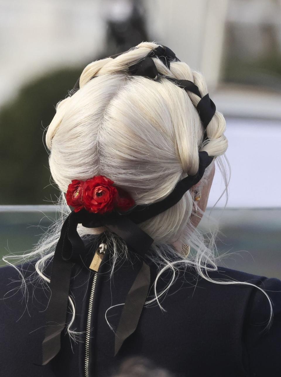 <p>The singer's braids were finished with a cluster of red flowers at the nape of her neck and were, in fact, a second day hairdo that Gaga had previously had styled the day before by go-to stylist Frederic Aspiras.</p>