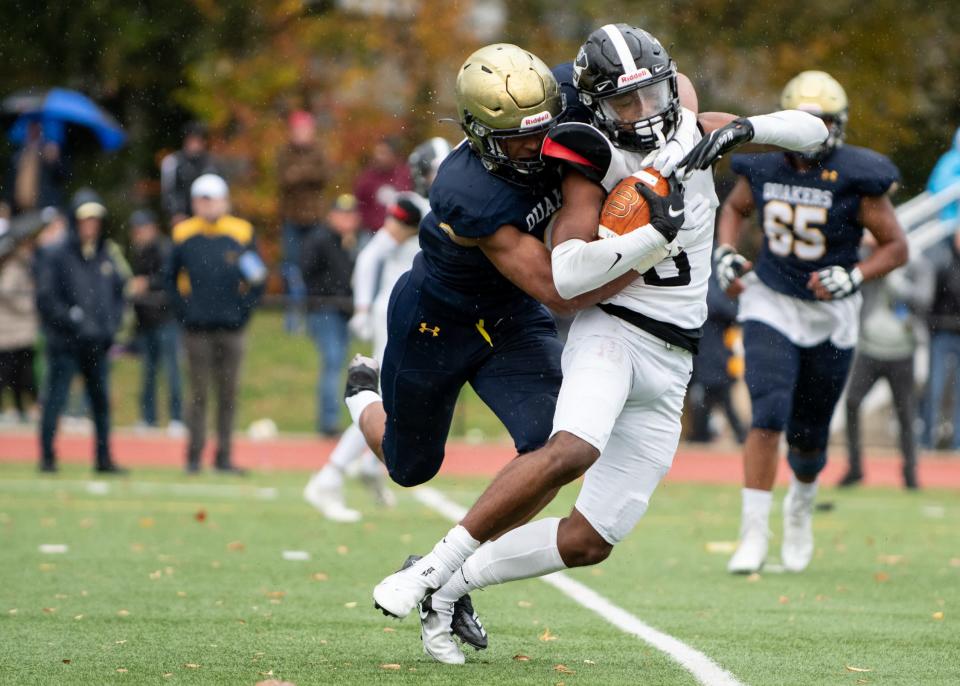 Germantown Academy wide receiver Evan Spivey is stopped by Penn Charter defensive end Isaiah Grimes during the 135th annual rivalry game in Philadelphia on Saturday, November 13, 2021. The Quakers defeated the Patriots 35-32.