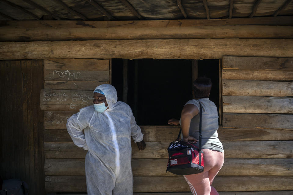 A nurse stands next to a sex worker outside a mobile HIV clinic in Ngodwana, South Africa, Thursday, July 2, 2020. Across Africa and around the world, the COVID-19 pandemic has disrupted the supply of antiretroviral drugs to many of the more than 24 million people who take them, endangering their lives. An estimated 7.7 million people in South Africa are HIV positive, the largest number in the world, and 62% of them take the antiretroviral drugs that suppress the virus and prevent transmission. (AP Photo/Bram Janssen)