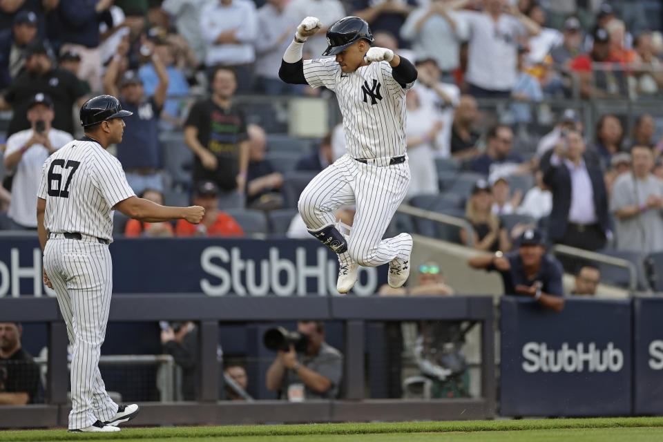 New York Yankees' Juan Soto celebrates with third base coach Luis Rojas (67) after hitting a two-run home run against the Houston Astros during the first inning of a baseball game Wednesday, May 8, 2024, in New York. (AP Photo/Adam Hunger)