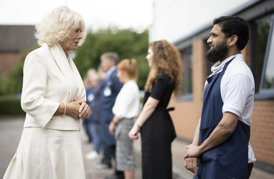 GLOUCESTER, ENGLAND - JULY 09: Camilla, Duchess of Cornwall speaks to a worker during a visit with Prince Charles, Prince of Wales to the Turnbull & Asser shirt factory on July 9, 2020 in Gloucester, United Kingdom. During the early stages of the Coronavirus pandemic the company switched their entire production line to making scrubs for the NHS. (Photo by Matthew Horwood/Getty Images)
