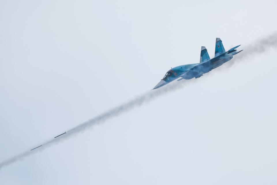 A Russian Sukhoi Su-34 fighter-bomber fires missiles during the Aviadarts competition, as part of the International Army Games 2021, at the Dubrovichi range outside Ryazan, Russia Aug. 27, 2021.