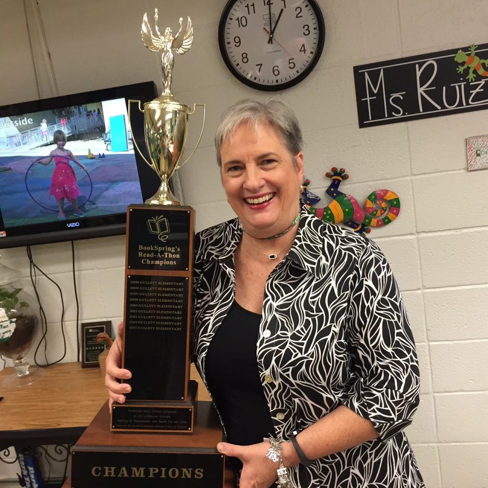 Superstar librarian Kay Gooch holds Gullett Elementary School's trophy for the BookSpring Read-a-Thon in 2016.