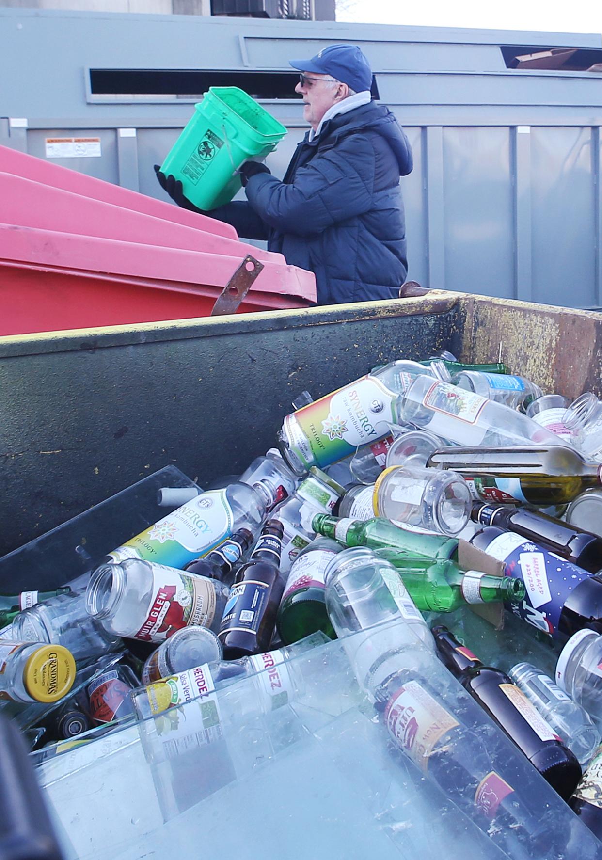 Ames resident Ed Cock recycle the newly installed containers for cardboard, plastics, paper, and glasses at Ames Resource Recovery on Tuesday, Jan. 2, 2024, in Ames, Iowa.