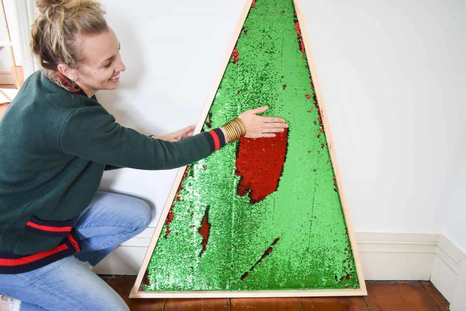 <p>We've all seen those oh-so-trendy mermaid sequins on throw pillows and notebooks, but have you ever seen them on a Christmas tree? Using red and green mermaid sequin fabric and plywood, this sparkling tree is brought to life. </p><p><strong>Get the tutorial at <a href="https://atcharlotteshouse.com/mermaid-sequin-christmas-tree/" rel="nofollow noopener" target="_blank" data-ylk="slk:At Charlotte’s House" class="link rapid-noclick-resp">At Charlotte’s House</a>.</strong></p><p><a class="link rapid-noclick-resp" href="https://www.amazon.com/gp/product/B077ZHZHZ2/?tag=syn-yahoo-20&ascsubtag=%5Bartid%7C10050.g.28872053%5Bsrc%7Cyahoo-us" rel="nofollow noopener" target="_blank" data-ylk="slk:SHOP MERMAID SEQUIN FABRIC">SHOP MERMAID SEQUIN FABRIC</a></p>