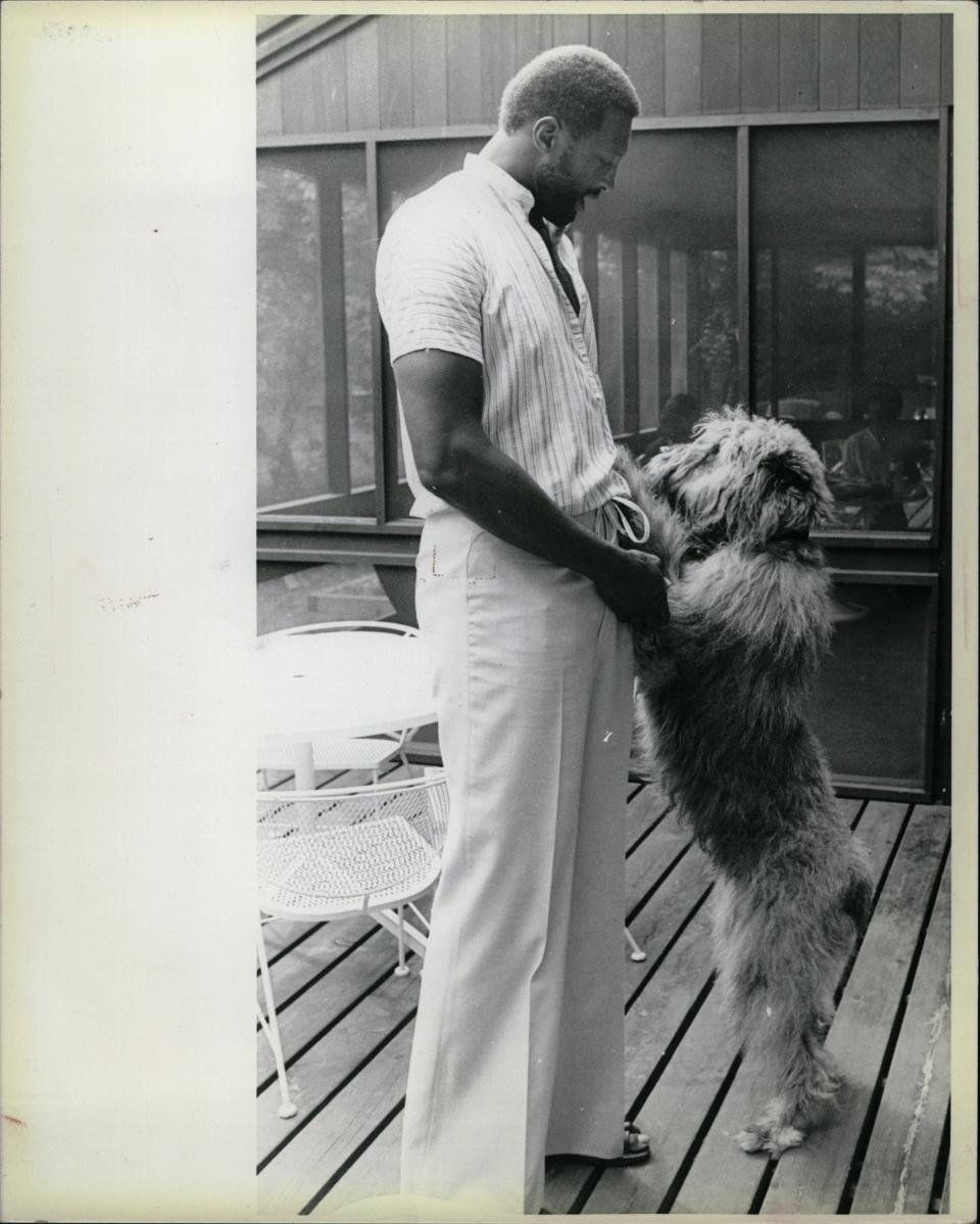 Bob Lanier, Detroit Pistons center, enjoys a moment with his pooch in August 1979, a few months before being traded to the Milwaukee Bucks.