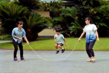 FILE PHOTO: Japan's Prince Hisahito jumps rope with his sisters Princess Mako and Princess Kako at their residence in Tokyo