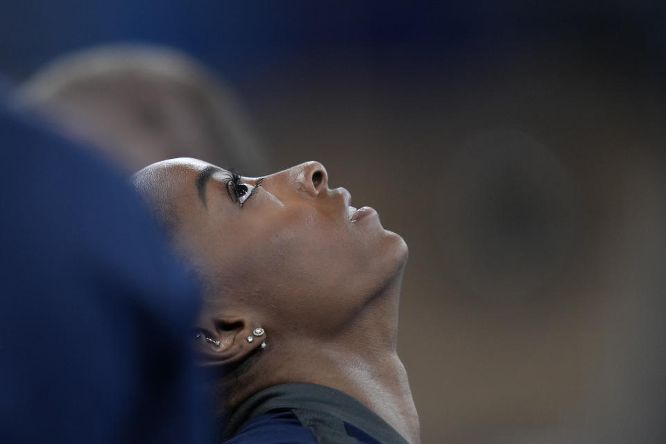 Simone Biles, of the United States, looks up after performing on the beam in the women's artistic gymnastic qualifications at the 2020 Summer Olympics, Sunday, July 25, 2021, in Tokyo. (AP Photo/Natacha Pisarenko)