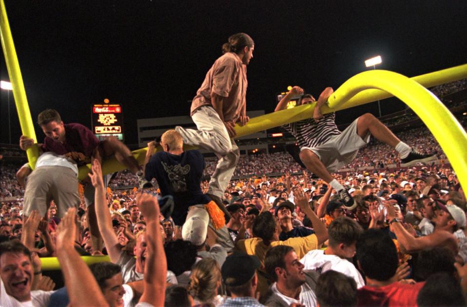 Arizona State fans tear the goalposts down as they celebrate the Sun Devils 19-0 win over Nebraska at Sun Devil Stadium in Tempe in 1996.