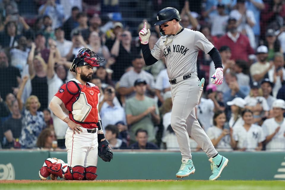 CORRECTS CATCHER TO CONNOR WONG, INSTEAD OF REESE MCGUIRE - New York Yankees' Alex Verdugo celebrates his two-run home run, next to Boston Red Sox catcher Connor Wong during the first inning of a baseball game Friday, June 14, 2024, in Boston. (AP Photo/Michael Dwyer)