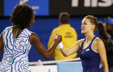 Venus Williams (L) of the U.S. shakes hands with Agnieszka Radwanska of Poland after winning their women's singles fourth round match at the Australian Open 2015 tennis tournament in Melbourne January 26, 2015. REUTERS/Issei Kato