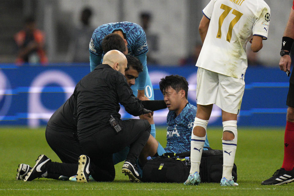 Tottenham's Son Heung-min receives treatment after taking a knock during the Champions League Group D soccer match between Marseille and Tottenham Hotspur at the Stade Velodrome in Marseille, France, Tuesday, Nov. 1, 2022. (AP Photo/Daniel Cole)