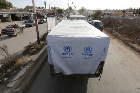 A convoy carrying humanitarian goods wait to enter the besieged area of Moudamiya Al Sham in the suburbs of Damascus, Syria February 17, 2016. REUTERS/Omar Sanadiki