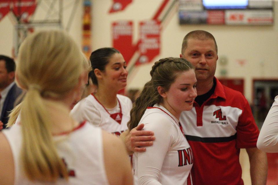 Twin Lakes senior Olivia Nickerson (back) embraces her father and assistant coach Troy Nickerson (right) after becoming the new Indiana high school 3-point record holder on Wednesday, Dec. 27, 2023