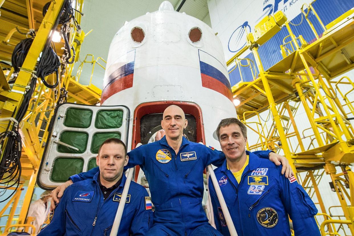 At the Baikonur Cosmodrome in Kazakhstan, Expedition 63 crew members Ivan Vagner (left) and Anatoly Ivanishin (center) of Roscosmos and NASA astronaut Chris Cassidy (right) pose for pictures April 3 in front of their Soyuz spacecraft as part of their prelaunch activities: Roscosmos