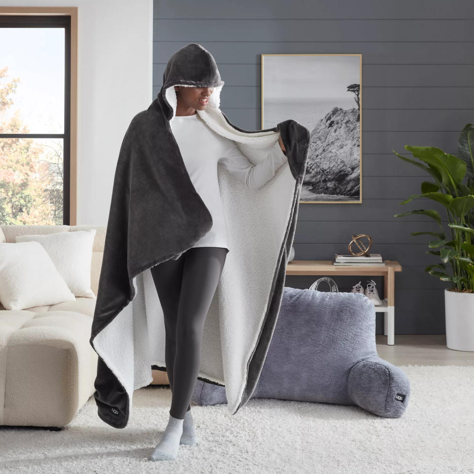 woman wears UGG Avery Hooded Throw Blanket in Charcoal in living room gift idea