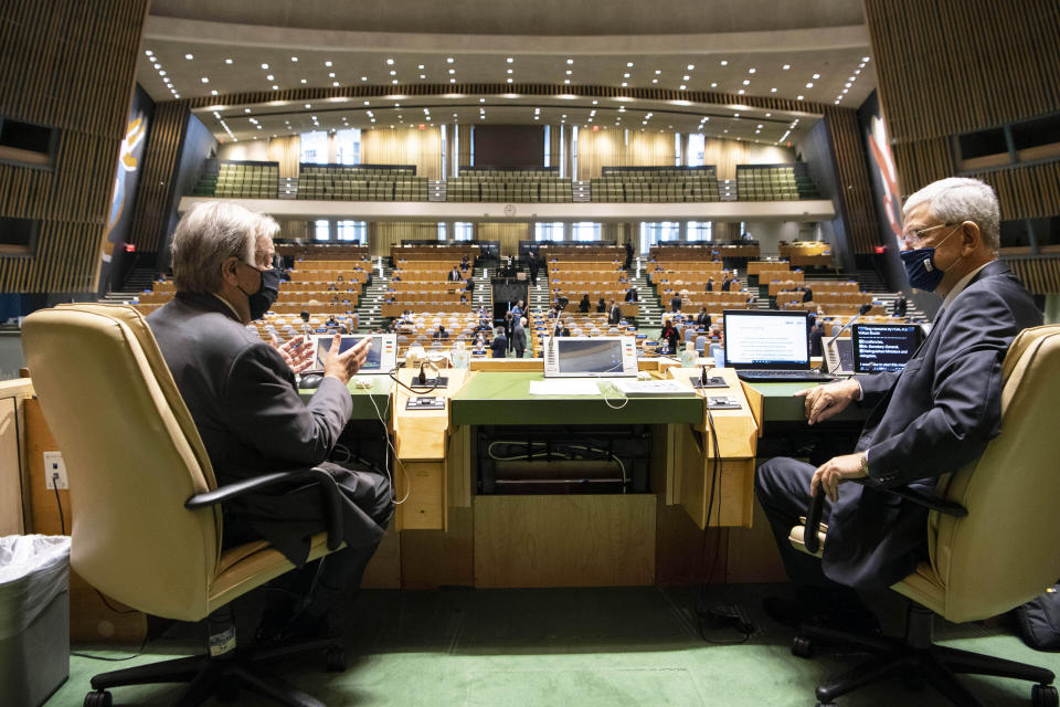 In this photo provided by the United Nations, United Nations Secretary-General Antonio Guterres, left, and General Assembly President Volkan Bozkir, from Turkey, confer prior to the start of the General Assembly meeting commemorating the 75th anniversary of the United Nations, Monday, Sept, 21, 2020. (Eskinder Debebe/United Nations via AP)