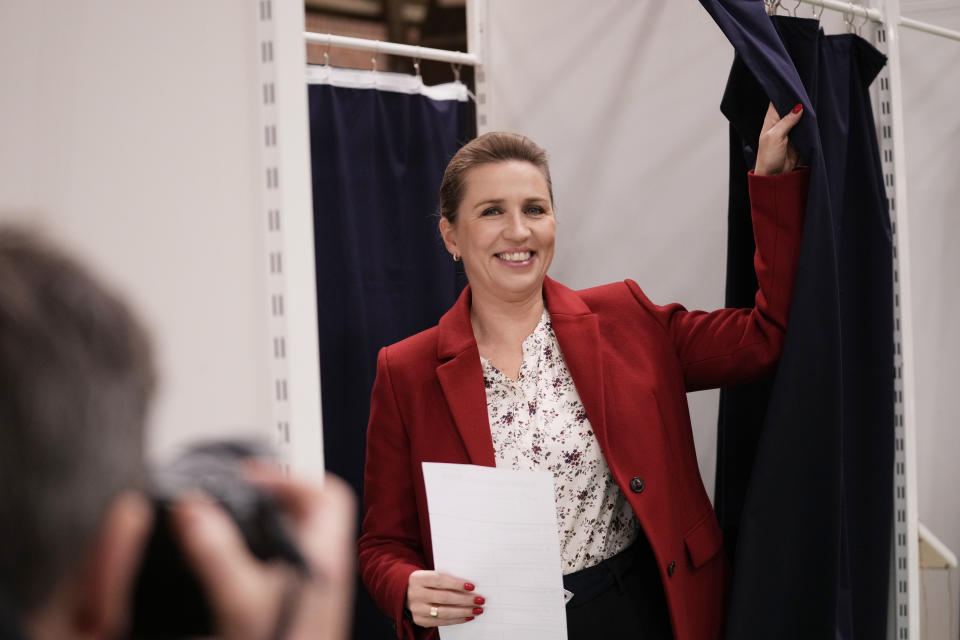 Danish Prime Minister Mette Frederiksen smiles before casting at a polling station in Hareskovhallen in Vaerloese, Denmark, on Tuesday, Nov 1, 2022. Denmark's election on Tuesday is expected to change its political landscape, with new parties hoping to enter parliament and others seeing their support dwindle. A former prime minister who left his party to create a new one this year could end up as a kingmaker, with his votes being needed to form a new government. (AP Photo/Sergei Grits)