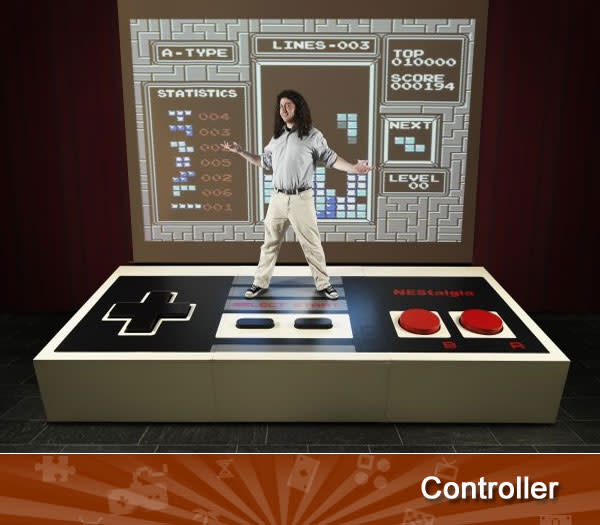 CONTROLLER -- Playing a video game on a giant TV is pretty standard these days, as 55" and 60" sets are commonplace. But a giant controller? Now that's unique! British engineering student Ben Allen spent $6,000 to create a <a href="http://games.yahoo.com/blogs/plugged-in/massive-nes-controller-biggest-ever-193049106.html" data-ylk="slk:12-foot wide NES controller;elm:context_link;itc:0;sec:content-canvas;outcm:mb_qualified_link;_E:mb_qualified_link;ct:story;" class="link  yahoo-link">12-foot wide NES controller</a> that weighs 265 pounds. The best part? It's fully functional. Earlier this year, Guinness has certified it as the world's biggest controller.