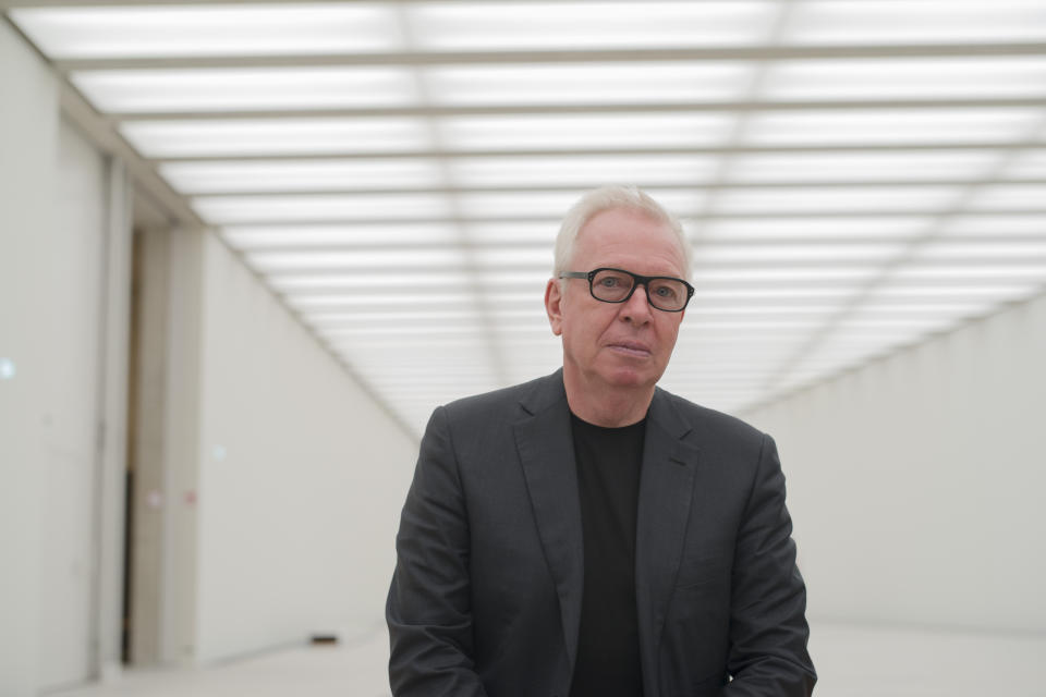 In this Monday, July 1, 2019 photo, architect David Chipperfield poses for media in a hall of the James-Simon-Galerie at the Museumsinsel, Museums Island, in Berlin, Germany. The building, designed by David Chipperfield, is the new central entrance building for the museums at the Museumsinsel of the German capital. (AP Photo/Markus Schreiber)