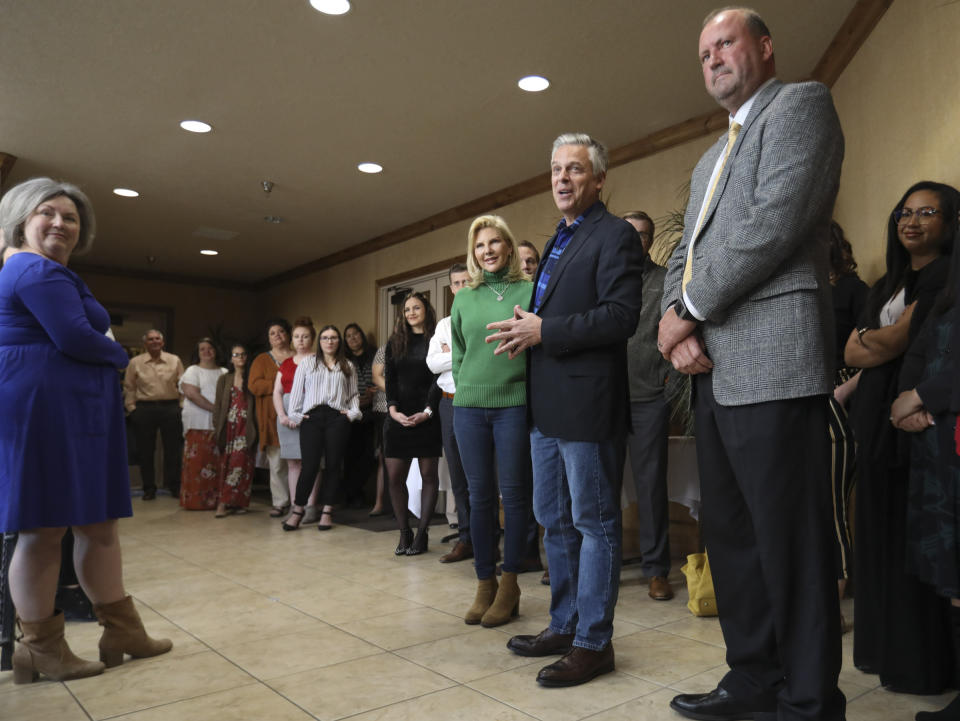 Jon Huntsman Jr., second from right, and his wife Mary Kaye talk with employees and clients at KKOS Lawyers and K&E CPAs in their offices in Cedar City, Utah, shortly after announcing that he is running for a third term as Utah's governor Thursday, Nov. 14, 2019. (Steve Griffin/The Deseret News via AP)
