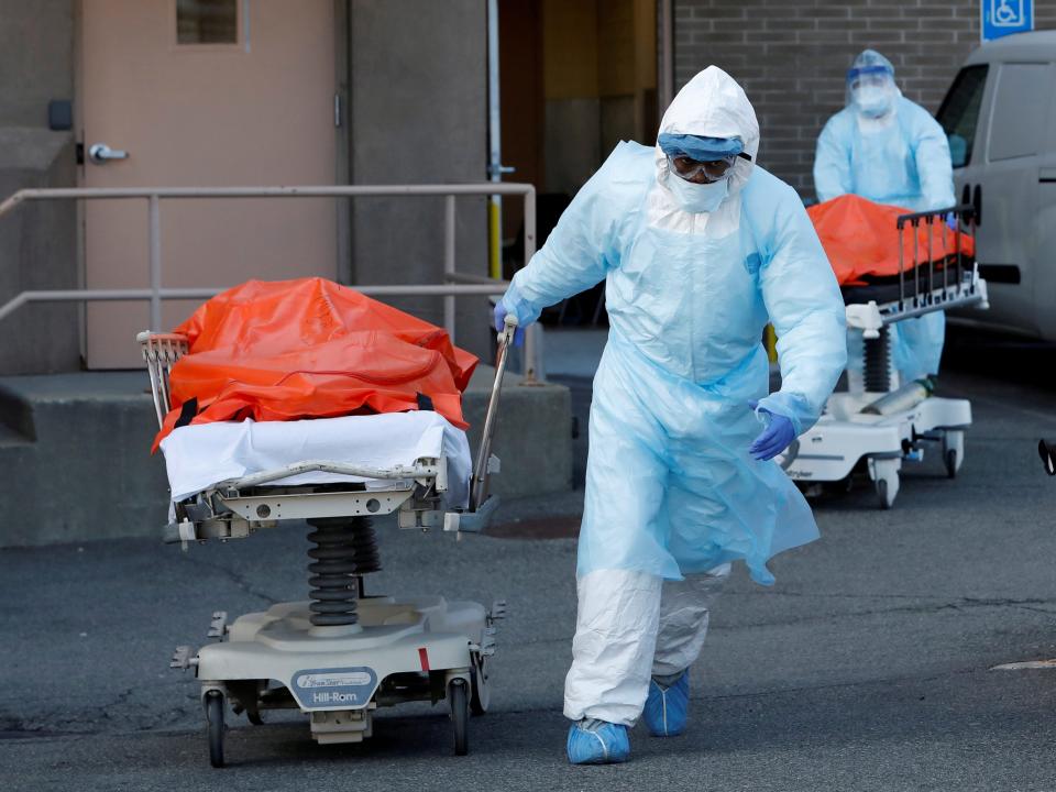 FILE PHOTO: Healthcare workers wheel the bodies of deceased people from the Wyckoff Heights Medical Center during the outbreak of the coronavirus disease (COVID-19) in the Brooklyn borough of New York City, New York, U.S., April 4, 2020. REUTERS/Andrew Kelly