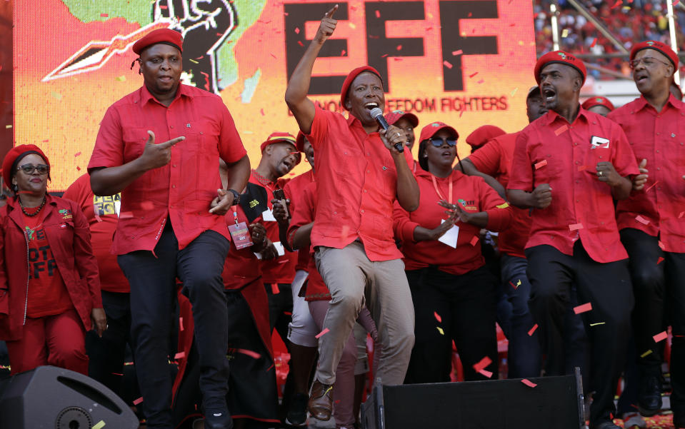 Leader of the Economic Freedom Fighters (EFF) party, Julius Malema, centre, with party members sing and dance after addressing supporters during an election rally at Orlando Stadium in Soweto, South Africa, Sunday, May 5, 2019. Campaign rallies for South Africa’s upcoming election have reached a climax Sunday with mass rallies by the ruling party and one of its most potent challengers. (AP Photo/Themba Hadebe)