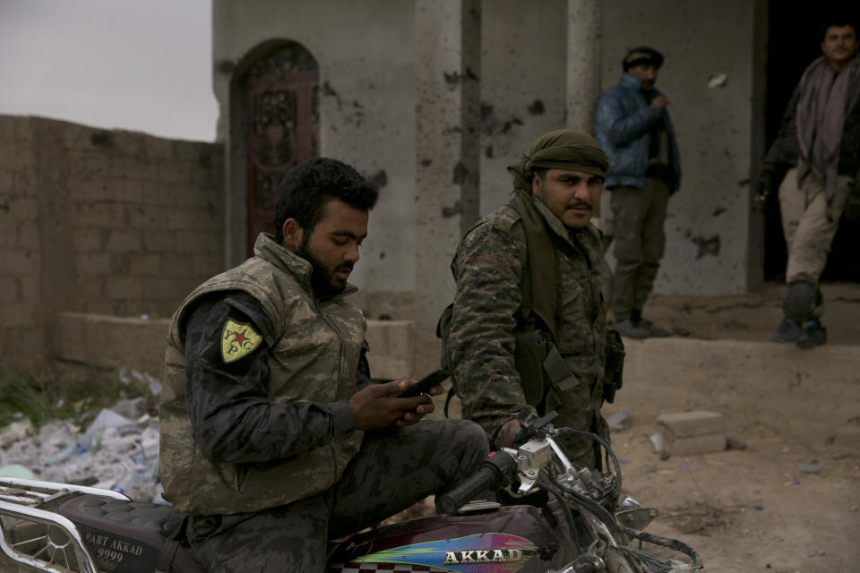U.S.-backed Syrian Democratic Forces (SDF) wait outside Baghouz, Syria, to go to the front line where Islamic State militants are staging counter attacks, Thursday, March 14, 2019. (AP Photo/Maya Alleruzzo)