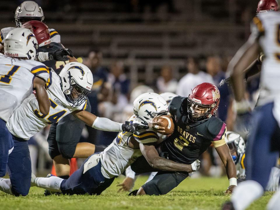 Lake Gibson (2) Fentrell Graham dives through Lehigh defenders during first half action at Lake Gibson High School in Lakeland Fl. Friday September 8 ,2023.Ernst Peters/The Ledger