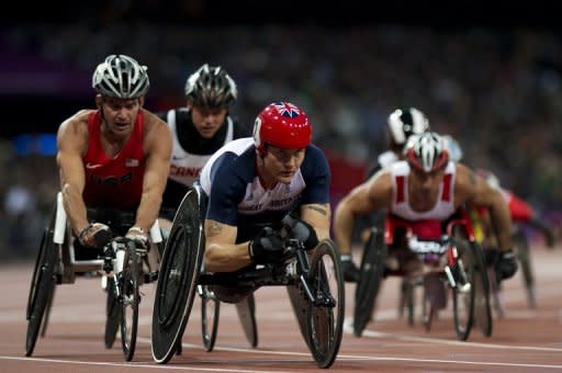 Britain's David Weir (C) competes in the men's 5,000m - T54 round 1 athletics track event during the London 2012 Paralympic Games at the Olympic Stadium in London on August 31. Packed crowds greeted the first day of athletics at the Paralympics but the jubilant mood was overshadowed by a mix-up that saw the wrong athlete awarded a gold